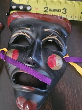 Decorative Black Carnival Mask with Red and Gold Accents